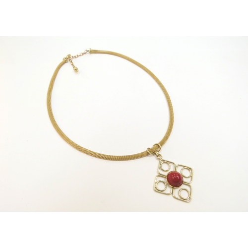 9068 - A gold fine woven chain necklace stamped 750 with a square form pendant with a central cabochon cora... 