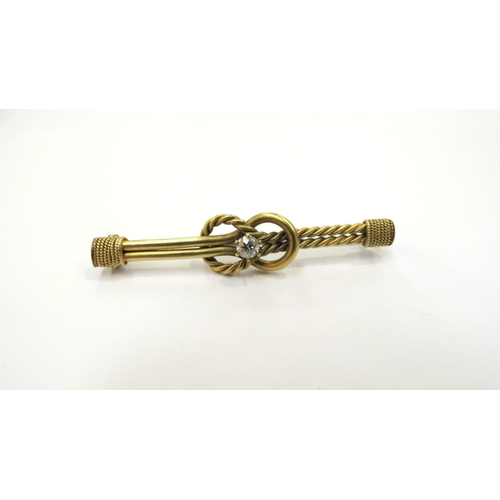 9053 - An unmarked gold brooch with single diamond to centre, metal pin, 5.2cm long, 5.8g total