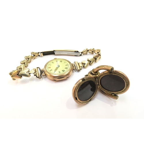 9278 - A 9ct gold cased wristwatch with a plated strap and a plated swivel fob with hinged opening revealin... 