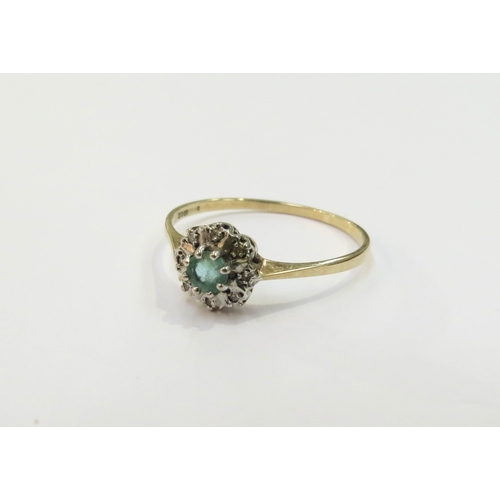 9099 - A 9ct gold emerald and diamond chip cluster ring. Size W, 1.4g