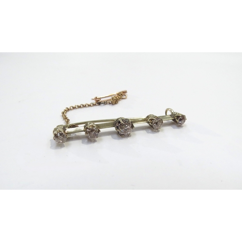 9097 - A bar brooch set with five graduated cinnamon diamonds, 0.65ct total approx, 4cm long, 3g