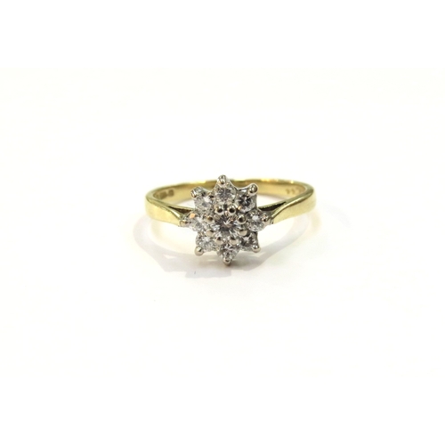 9126 - An 18ct gold diamond daisy ring. Size M, 2.8g