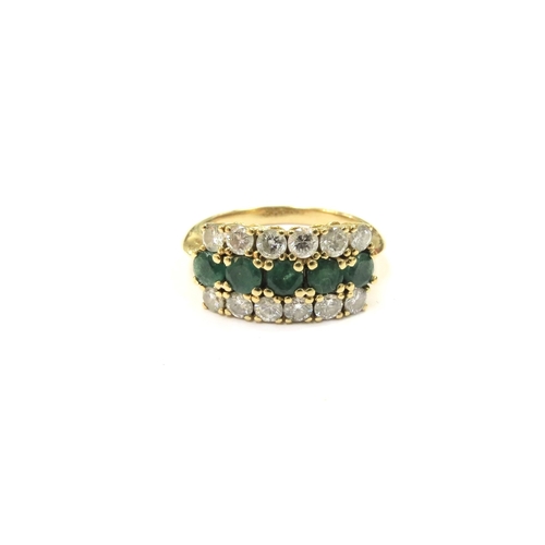 9002 - An emerald and diamond ring the central row of five emeralds set between rows of claw set brilliant ... 