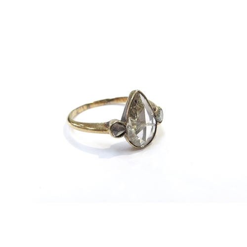 9039 - An unmarked gold ring set with a large old cut pear shaped diamond, crack running across the centre ... 