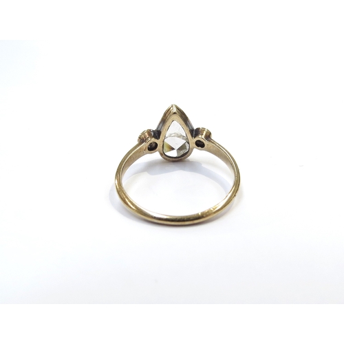 9039 - An unmarked gold ring set with a large old cut pear shaped diamond, crack running across the centre ... 