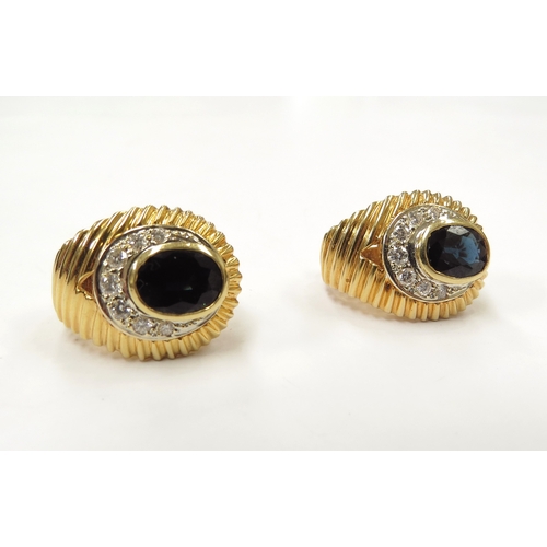 9032 - A pair of sapphire and diamond earrings, the oval sapphire framed by an arch of graduated diamonds, ... 