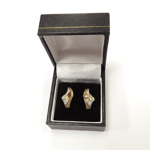 9062 - A pair of platinum and 18ct gold ruby and diamond earrings, 5.8g