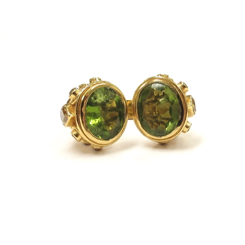 9067 - A silver gilt peridot Etruscan style ring. Size N, 13.5g