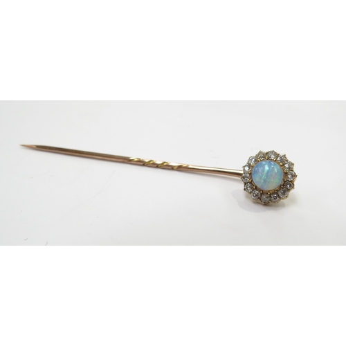 9100 - A gold stick pin with an opal and diamond cluster finial