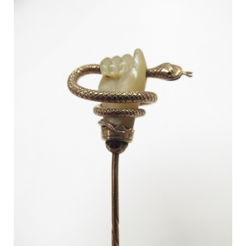 9094 - A gold stick pin with mother-of-pearl hand clenching a snake