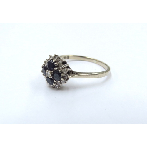 9291 - An 18ct gold sapphire and diamond cluster ring. Size N, 2.7g