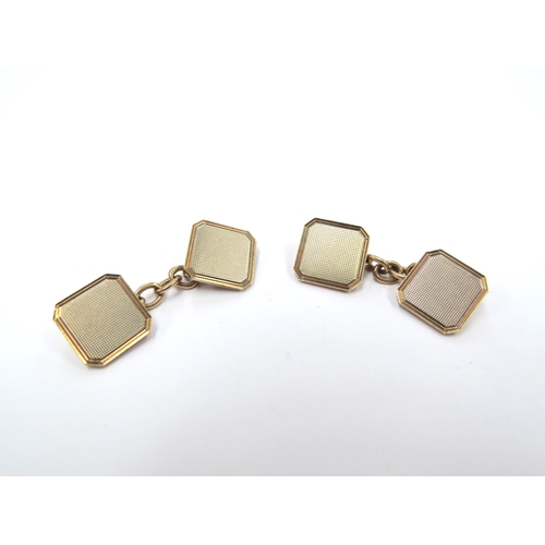 9382 - A pair of 9ct gold cufflinks of canted square form, engine turned decoration, 5.6g