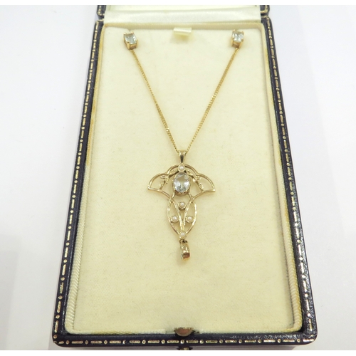 9075 - A 9ct gold Edwardian style pendant with seed pearl and aquamarine with an aquamarine droplet hung on... 