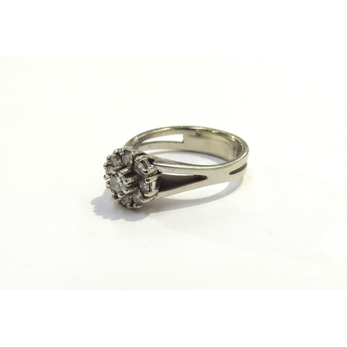 9213 - A 14ct white gold diamond daisy ring. Size N, 4.5g with certificate