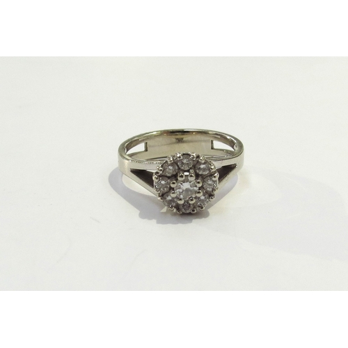 9213 - A 14ct white gold diamond daisy ring. Size N, 4.5g with certificate