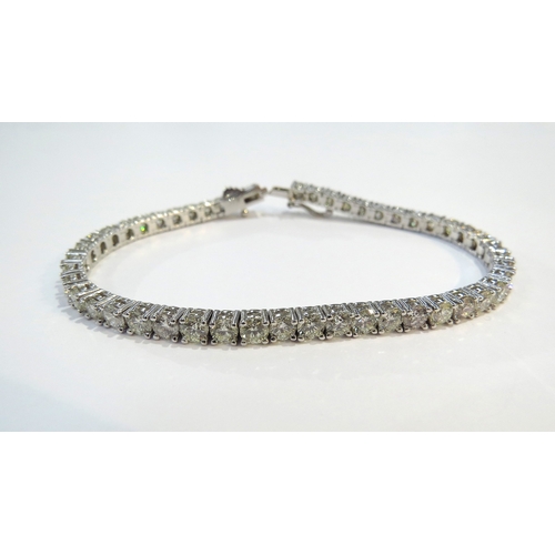 9114 - A diamond line bracelet with 49 round cut diamonds in four claw settings 7.35ct estimated total, sta... 