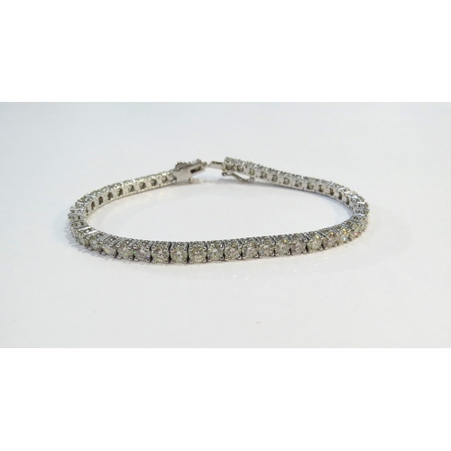 9114 - A diamond line bracelet with 49 round cut diamonds in four claw settings 7.35ct estimated total, sta... 