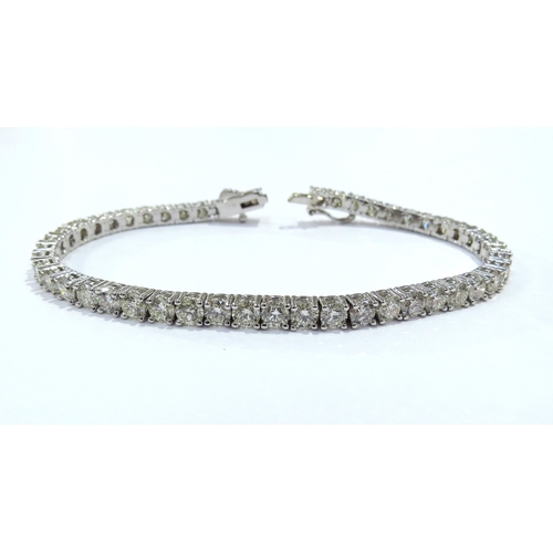 9114 - A diamond line bracelet with 49 round cut diamonds in four claw settings 7.35ct estimated total, sta... 