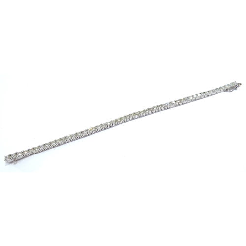 9114 - A diamond line bracelet with 49 round cut diamonds in four claw settings 7.35ct estimated total, sta... 