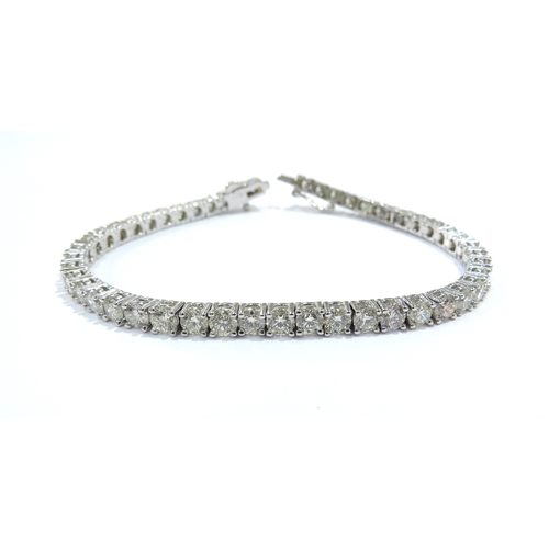 9114 - A diamond line bracelet with 49 round cut diamonds in four claw settings 7.35ct estimated total, sta... 