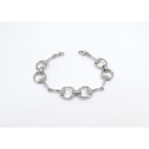 9023 - A Gucci 18ct white gold solid horse bit design bracelet with pave diamond set linking sections and e... 