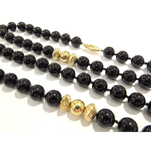 9217 - A French jet bead necklace with  gold spacer beads, gold clasp stamped 14k, 96cm long