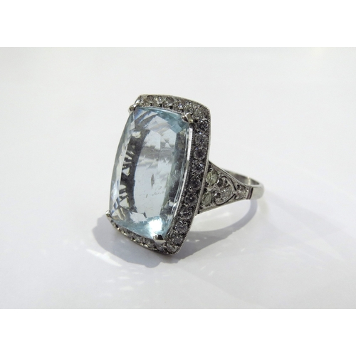 9158 - A cushion shaped aquamarine and diamond cluster ring the aquamarine 17mm x 112mm framed by 32 diamon... 