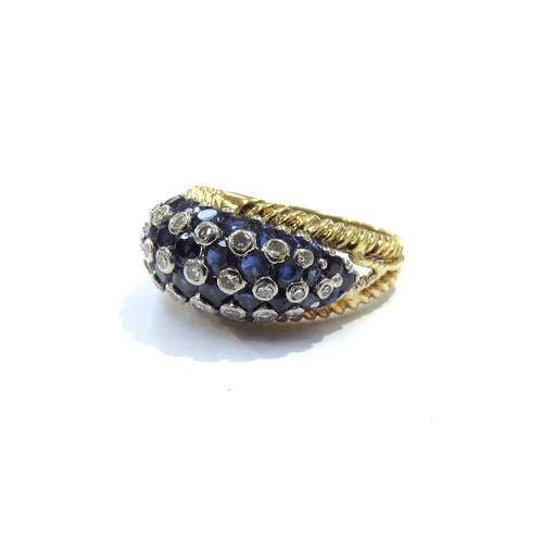 9160 - An 18ct yellow and white gold domed sapphire and diamond studded dress ring, invisible set sapphires... 