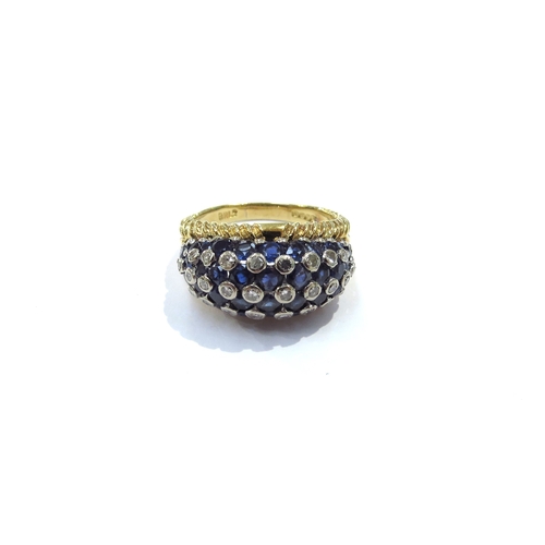 9160 - An 18ct yellow and white gold domed sapphire and diamond studded dress ring, invisible set sapphires... 