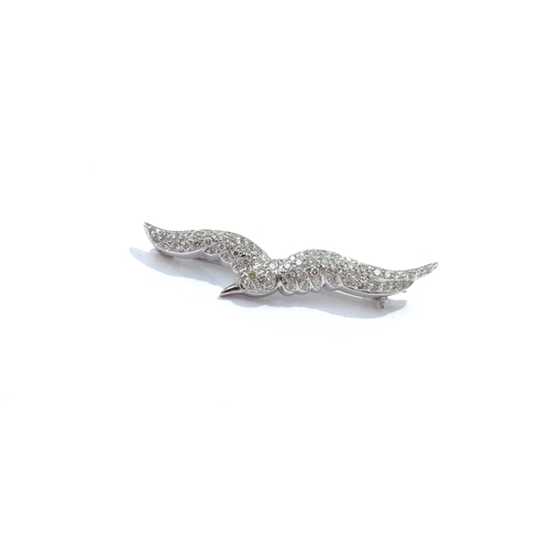 9087 - A diamond encrusted brooch as a seagull with a fancy yellow diamond set eye, 72 brilliant cut diamon... 