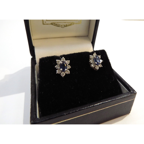 9165 - A pair of 18ct gold sapphire and diamond cluster earrings, 2.5g