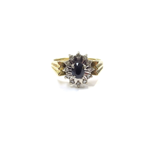 9204 - An 18ct gold sapphire and diamond cluster ring. Size M/N, 5g