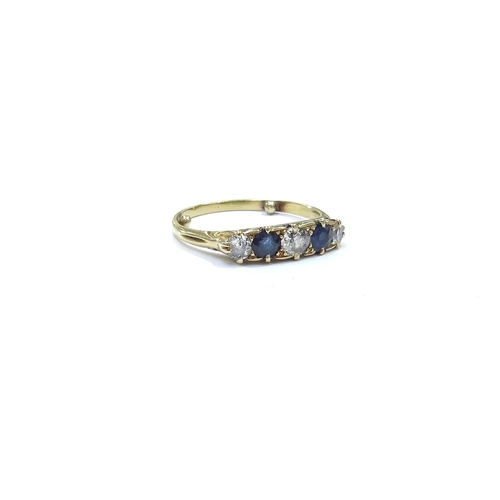 9118 - A five stone sapphire and diamond ring in scroll mount, unmarked 18ct gold. Size N+ (has spacer dots... 