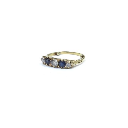 9118 - A five stone sapphire and diamond ring in scroll mount, unmarked 18ct gold. Size N+ (has spacer dots... 