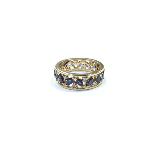 9135 - A sapphire and diamond eternity ring, pierced decoration, stamped 750. Size L/M, 4.6g