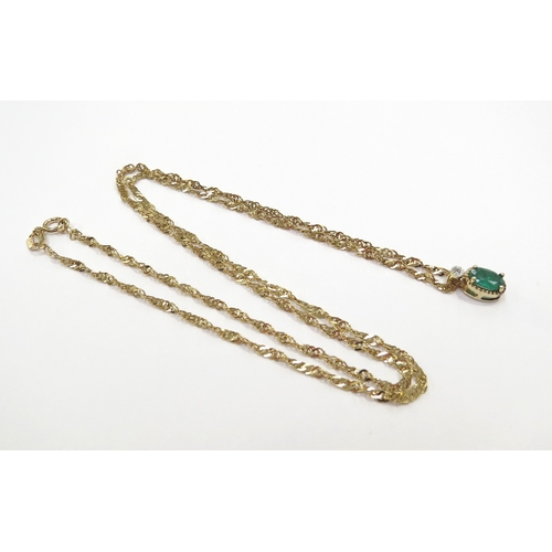 9090 - An emerald and diamond pendant hung on 9ct gold chain, 44cm long, 1.9g