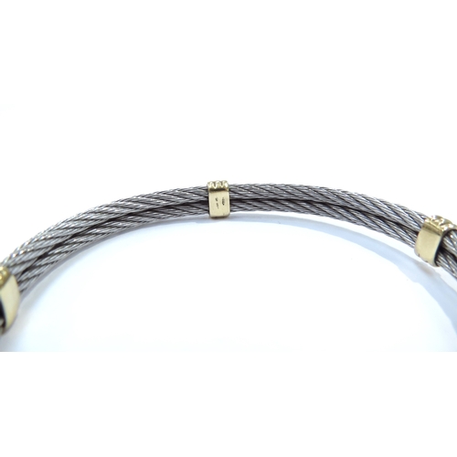 9195 - An 18ct gold and white metal bracelet the two twisted bands of white metal with yellow gold fastenin... 