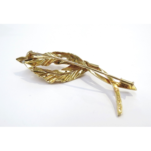 9054 - An 18ct gold leaf form brooch studded with 16 brilliant cut diamonds, 15.8g