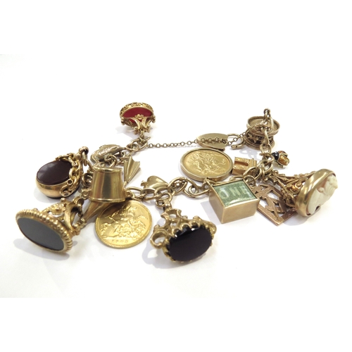 9069 - A 9ct gold charm bracelet hung with an 1892 gold sovereign, 1905 gold half sovereign, 9ct gold carou... 