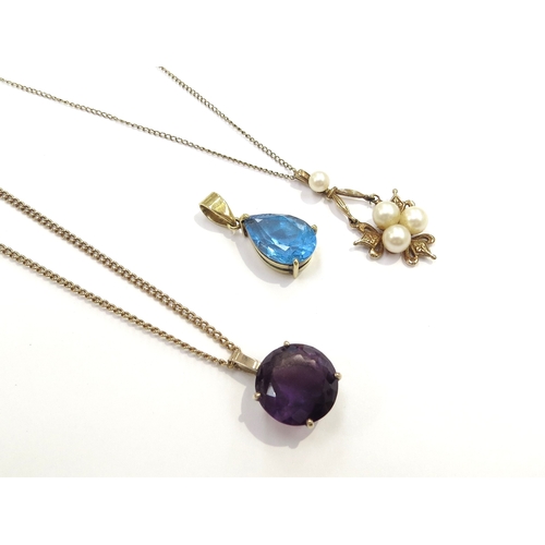 9377 - A 9ct gold chain hung with a pearl pendant, 9ct gold chain hung with an amethyst pendant and a topaz... 