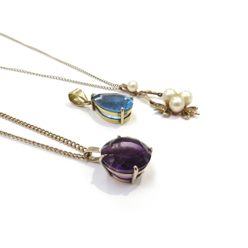 9377 - A 9ct gold chain hung with a pearl pendant, 9ct gold chain hung with an amethyst pendant and a topaz... 