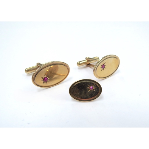 9212 - A pair of 9ct gold cufflinks set with a single small ruby and a matching stud, 7.2g