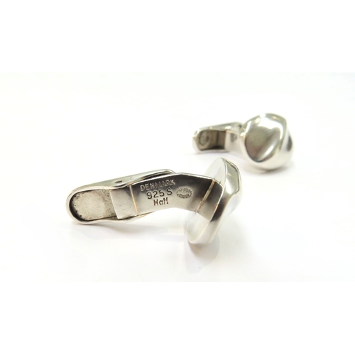 9396 - A pair of Georg Jensen silver cushion shape cufflinks with a curved diagonal ridge on an arched spru... 