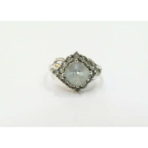 9257 - A 9ct white gold ring with pale blue stone cluster. Size M/N, 2.9g