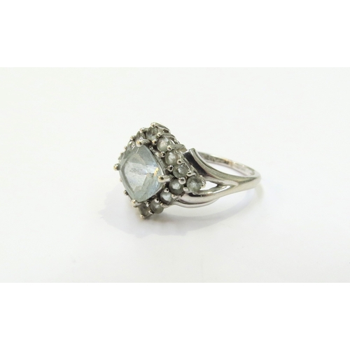 9257 - A 9ct white gold ring with pale blue stone cluster. Size M/N, 2.9g