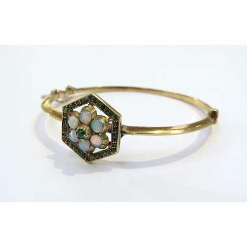 9040 - A Victorian gold hinged bangle set with opals and green stones in a hexagon framed, marked 15ct, som... 