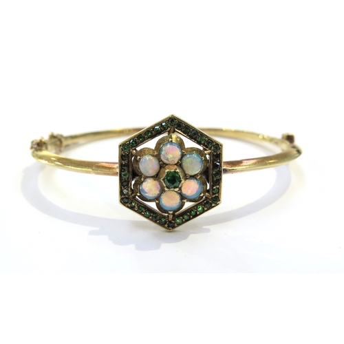 9040 - A Victorian gold hinged bangle set with opals and green stones in a hexagon framed, marked 15ct, som... 