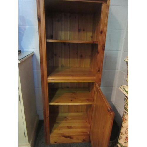 1009 - A Victorian style natural pine narrow cabinet, the single drawer over an open shelf and single door ... 