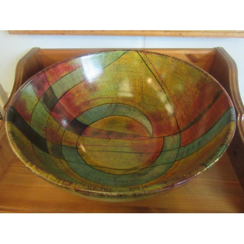 1020 - A pottery bowl in greens, ochre, blue and terracotta, 36cm diameter