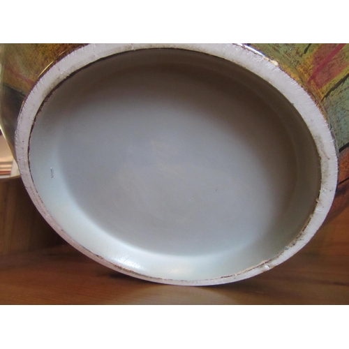 1020 - A pottery bowl in greens, ochre, blue and terracotta, 36cm diameter